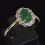 entourage-ring-yellow-gold-oval-emerald-round-conflict-free-diamonds-cluster-engagement-lady-di